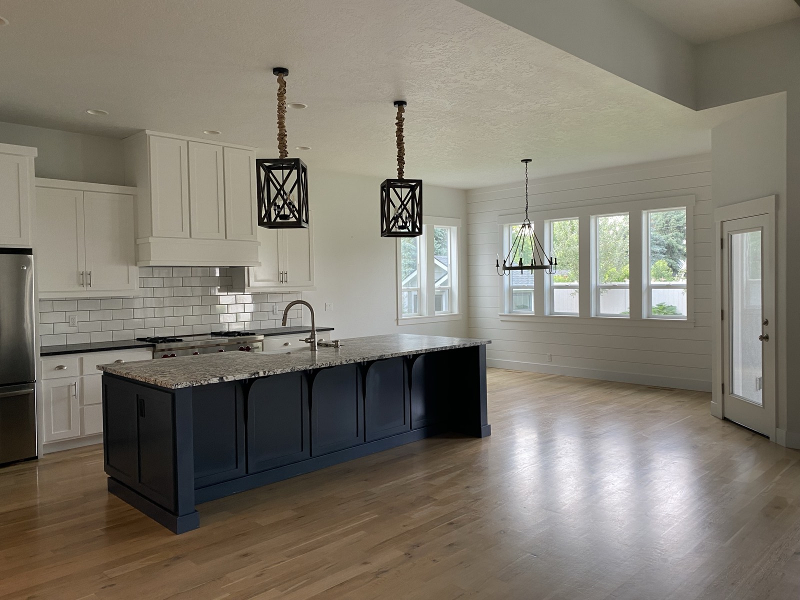 Beamed great room with stone fireplace in the Craftsman Retreat custom home