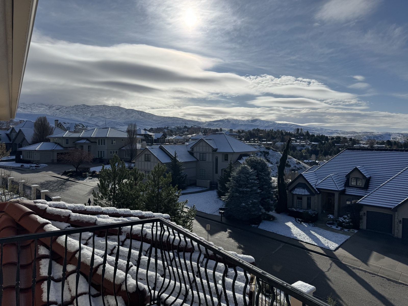 Snow-dusted hillside neighborhood with mountain views from the terrace