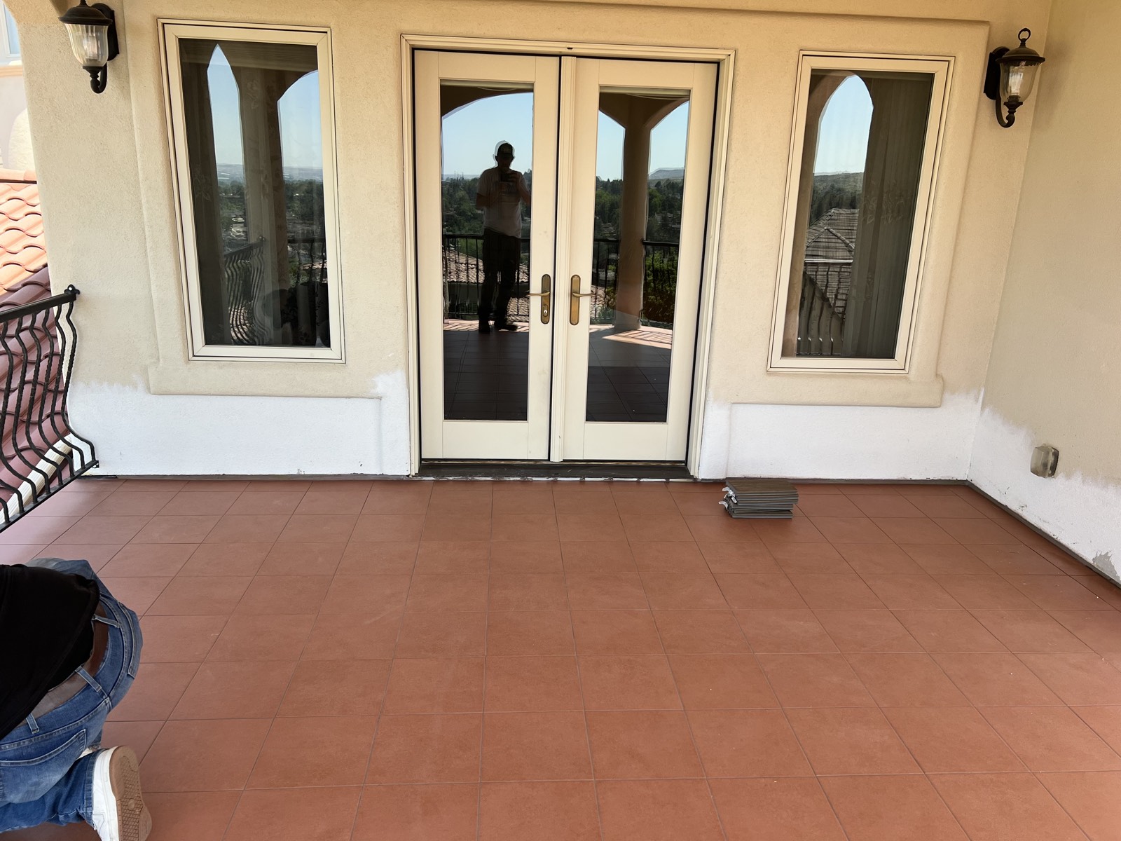New tile floor on a covered terrace with French doors