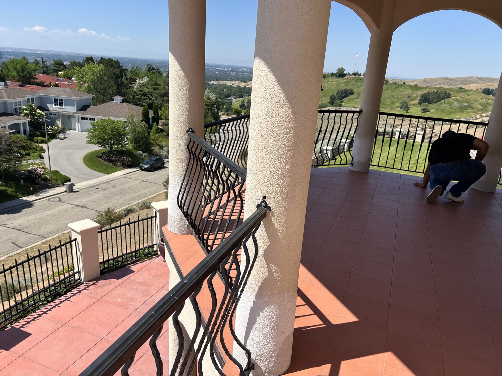 Arched terrace with wrought-iron railing overlooking the valley