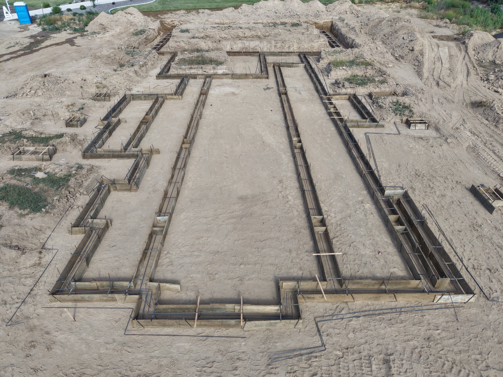 Aerial view of engineered foundation layout on a custom home site