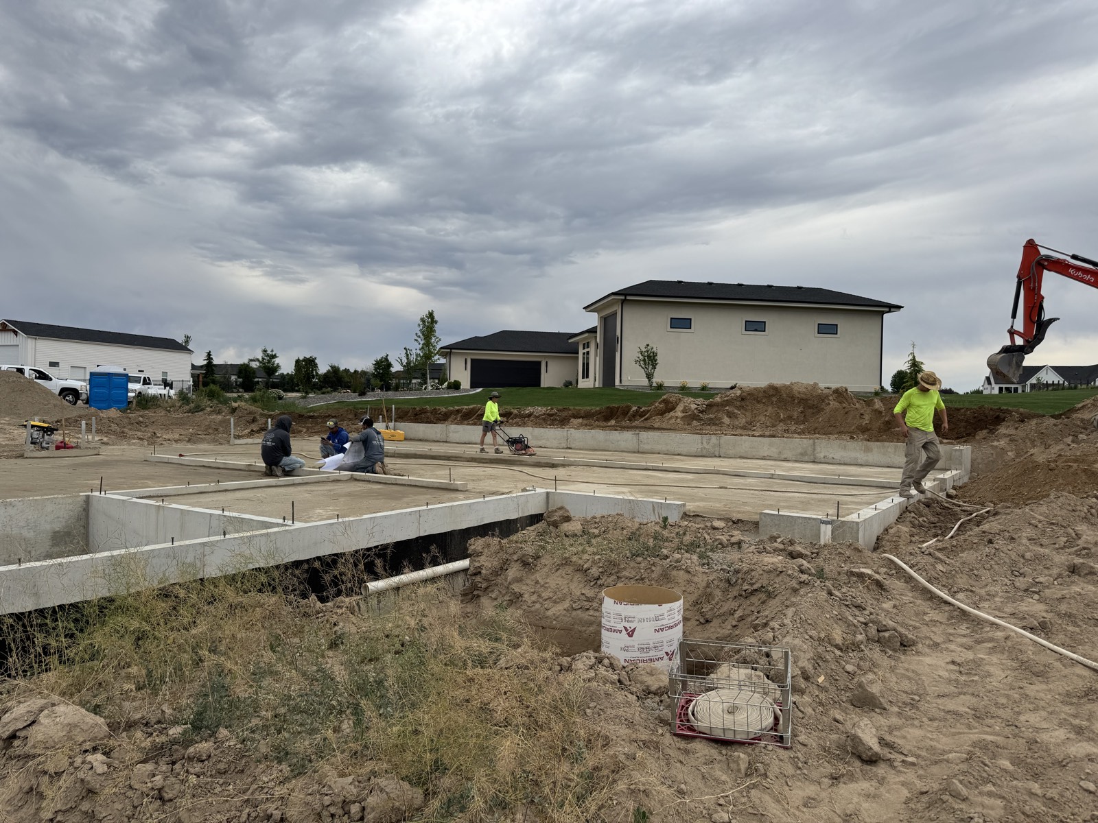 Crew placing concrete for a custom home foundation