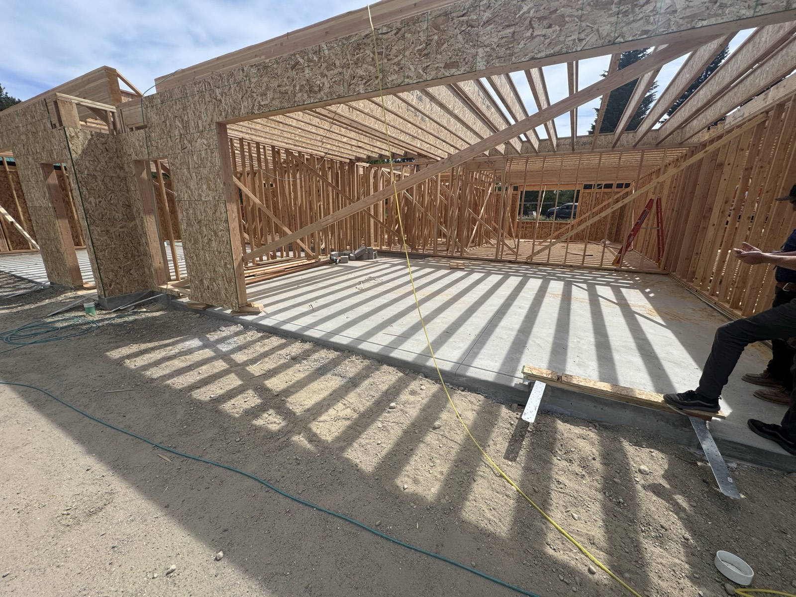 Garage framing casting long shadows on a mountain townhomes