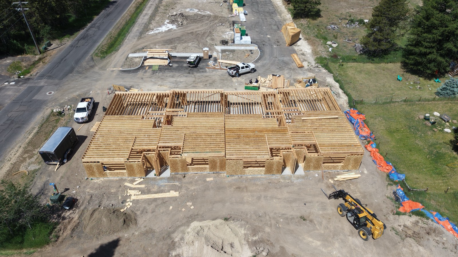 Aerial view of foundation work surrounded by pines