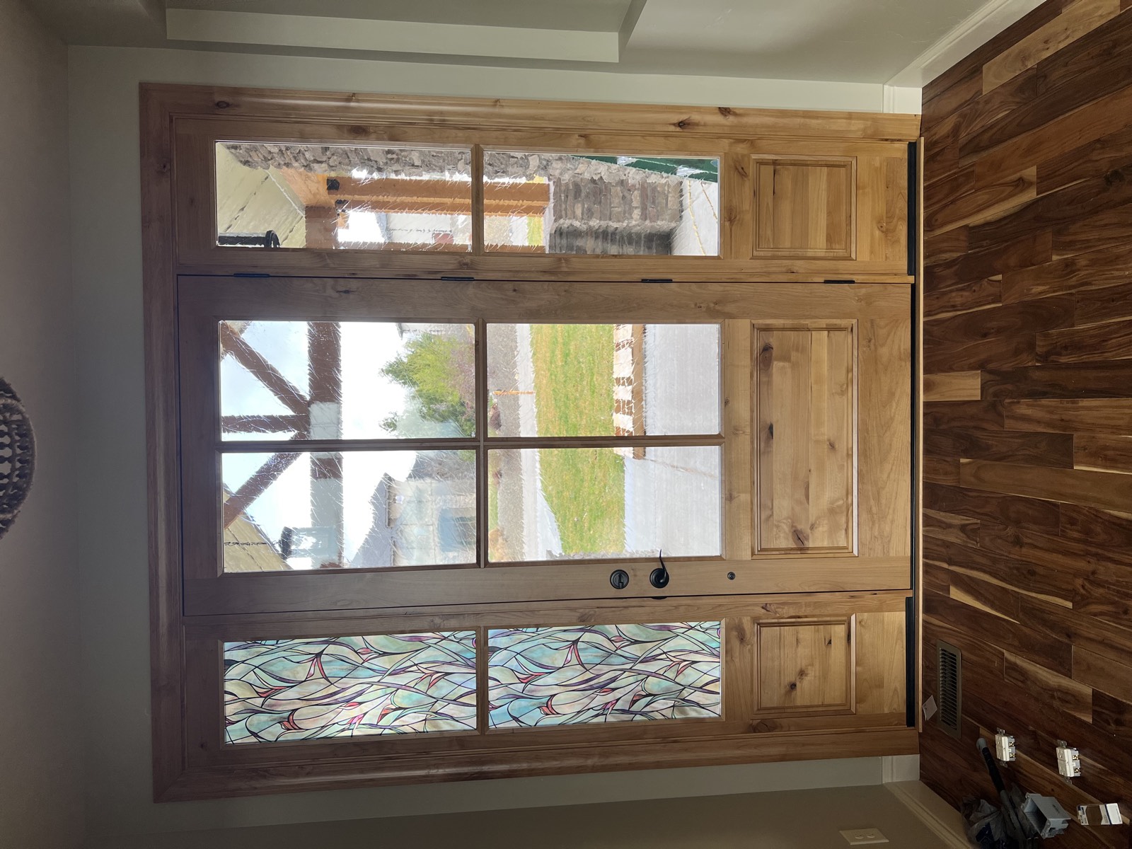 Handcrafted knotty alder entry door with art glass sidelites