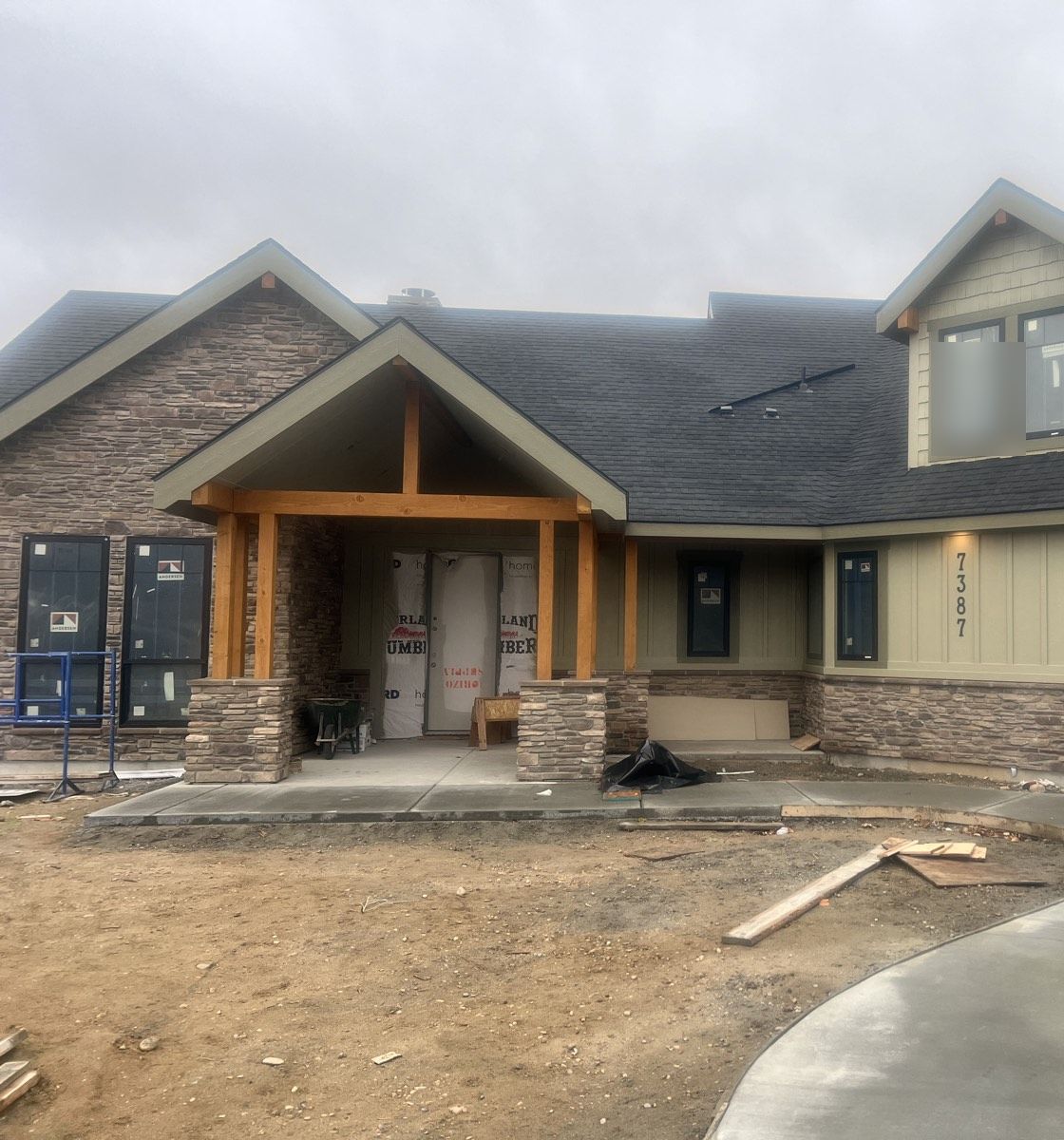 Craftsman custom home exterior with stone and timber accents